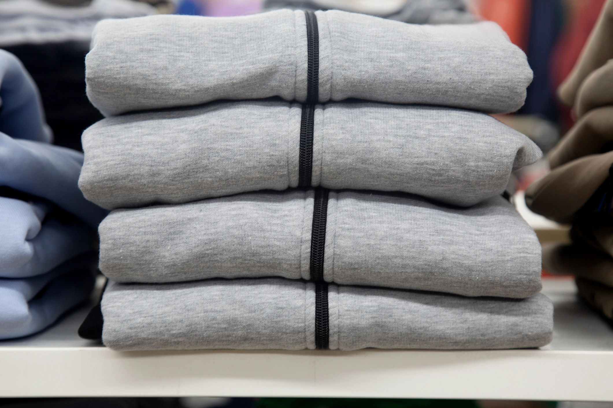 Neatly stacked polo shirts on a shelf