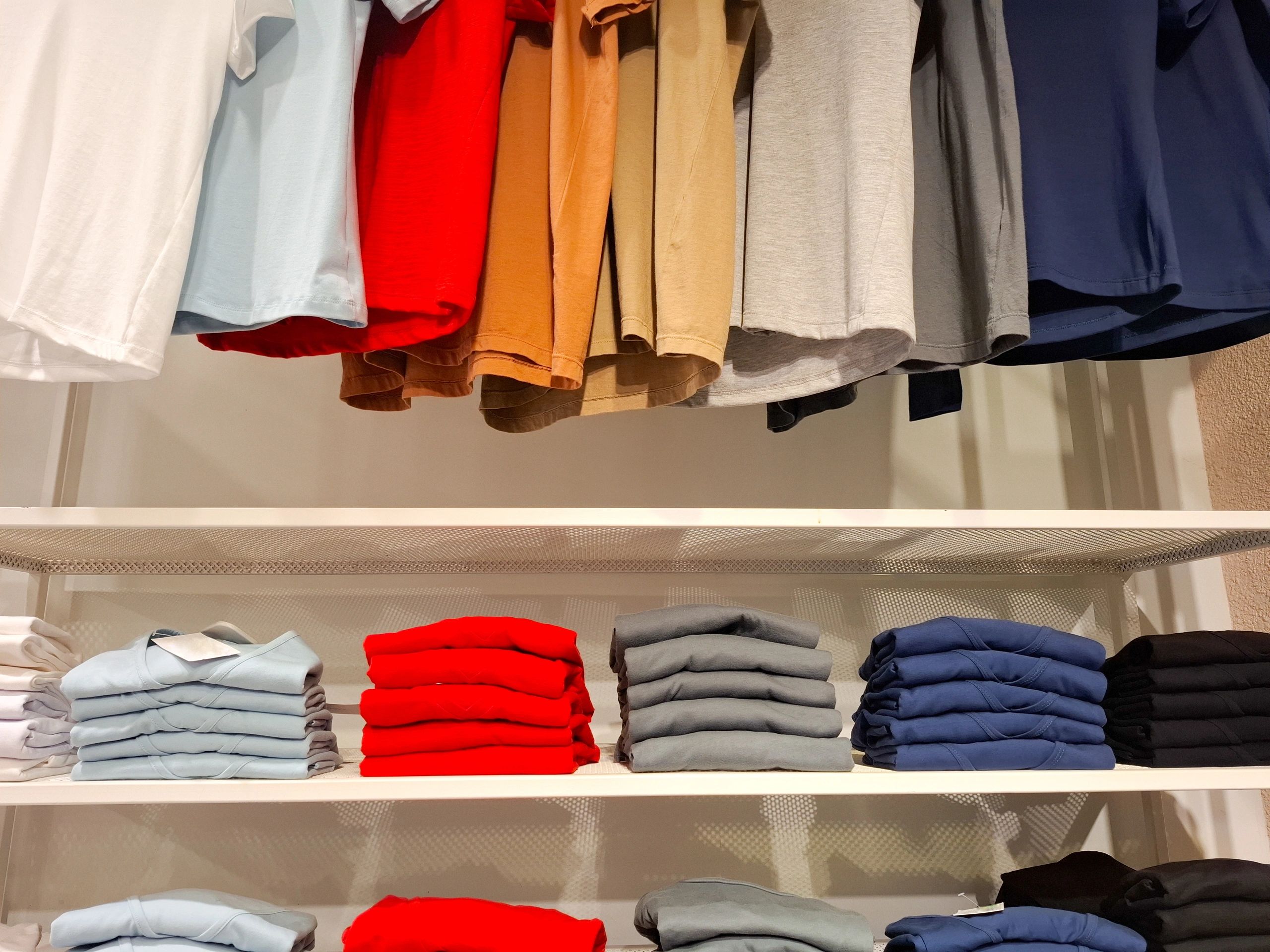 Colourful apparel and folded garments on shelves