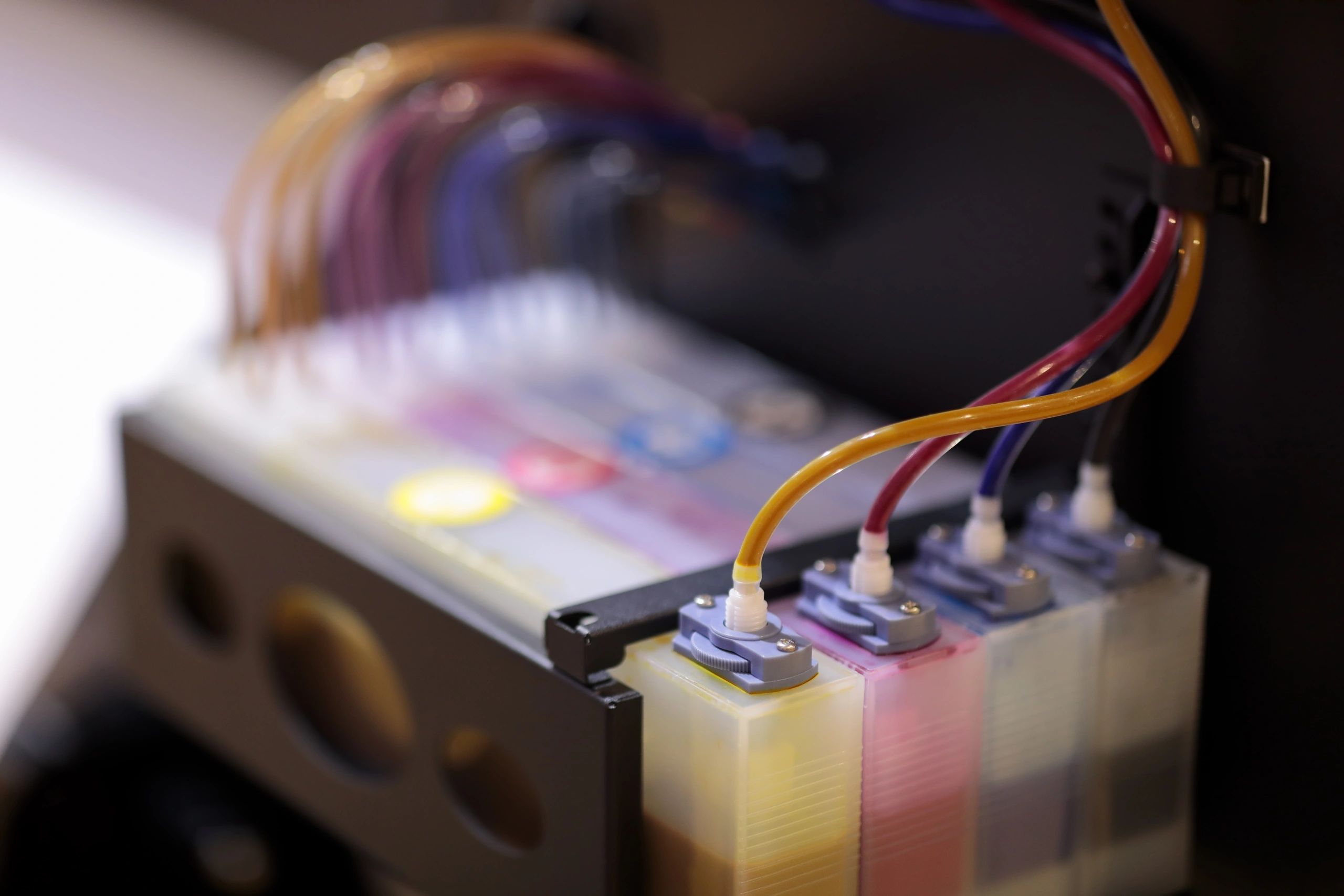 Industrial printer ink tanks representing production capacity